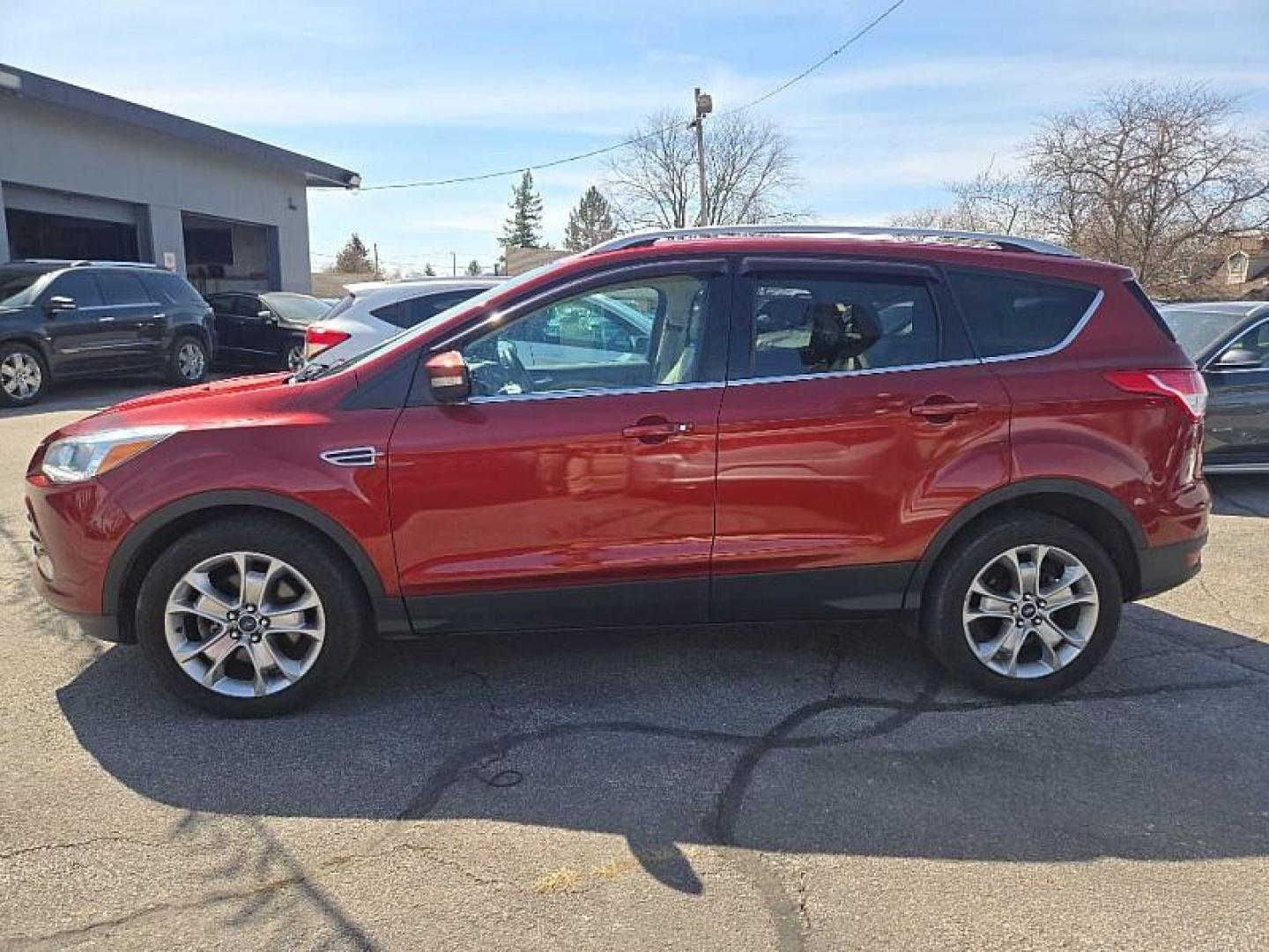 2014 ORANGE /TAN Ford Escape Titanium 4WD (1FMCU9J98EU) with an 2.0L L4 DOHC 16V engine, 6-Speed Automatic transmission, located at 3304 Woodville Road, Northwood, OH, 43619, (419) 210-8019, 41.612694, -83.480743 - Your #1 Destination for Auto Loans and mdash;No Matter Your Credit!At our dealership, we believe everyone deserves the opportunity to drive their dream car and mdash;whether you have good credit, bad credit, or no credit at all. With a wide selection of hundreds of cars, trucks, and SUVs, you'll fin - Photo#1