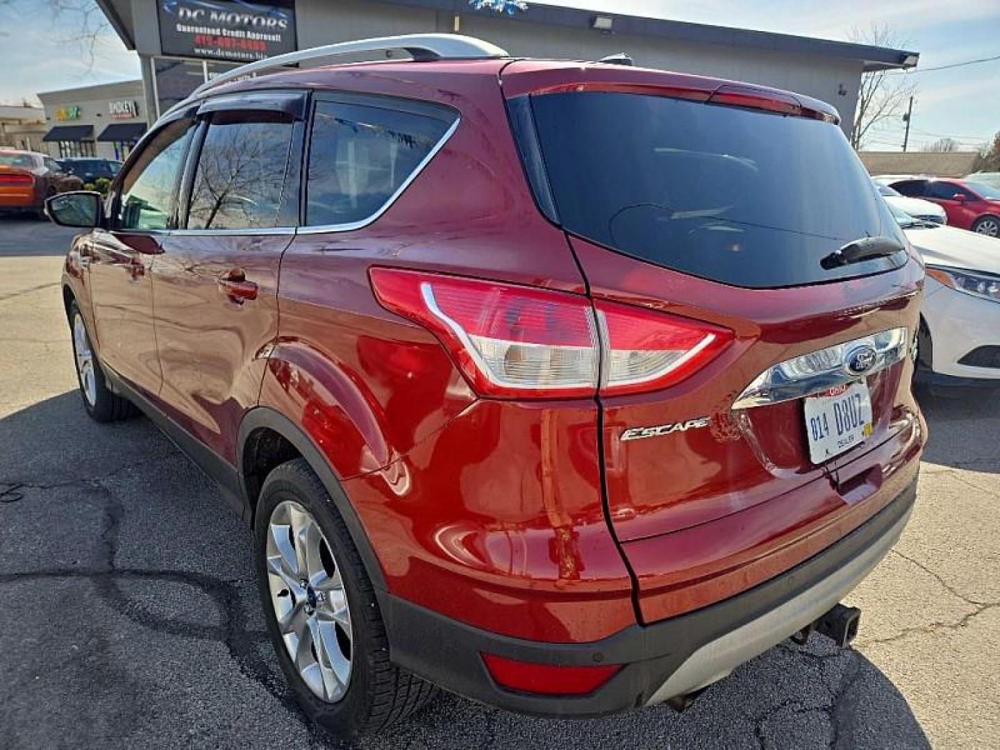 2014 ORANGE /TAN Ford Escape Titanium 4WD (1FMCU9J98EU) with an 2.0L L4 DOHC 16V engine, 6-Speed Automatic transmission, located at 3304 Woodville Road, Northwood, OH, 43619, (419) 210-8019, 41.612694, -83.480743 - Your #1 Destination for Auto Loans and mdash;No Matter Your Credit!At our dealership, we believe everyone deserves the opportunity to drive their dream car and mdash;whether you have good credit, bad credit, or no credit at all. With a wide selection of hundreds of cars, trucks, and SUVs, you'll fin - Photo#2