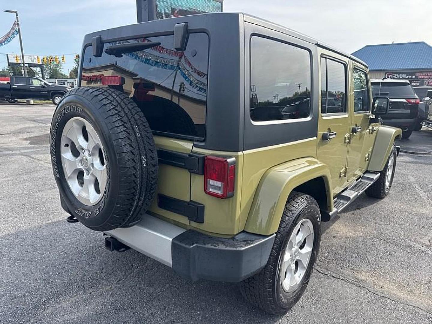 2013 GREEN /BLACK Jeep Wrangler Unlimited Sahara 4WD (1C4BJWEG0DL) with an 3.6L V6 DOHC 24V FFV engine, Automatic 5-Spd transmission, located at 3304 Woodville Road, Northwood, OH, 43619, (419) 210-8019, 41.612694, -83.480743 - Your #1 Destination for Auto Loans and mdash;No Matter Your Credit!At our dealership, we believe everyone deserves the opportunity to drive their dream car and mdash;whether you have good credit, bad credit, or no credit at all. With a wide selection of hundreds of cars, trucks, and SUVs, you'll fin - Photo#4