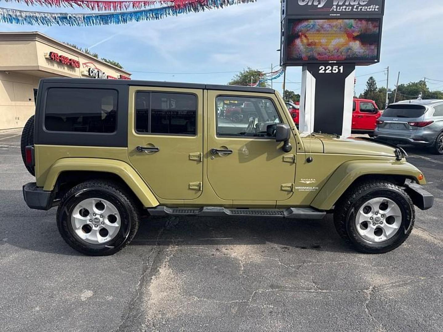 2013 GREEN /BLACK Jeep Wrangler Unlimited Sahara 4WD (1C4BJWEG0DL) with an 3.6L V6 DOHC 24V FFV engine, Automatic 5-Spd transmission, located at 3304 Woodville Road, Northwood, OH, 43619, (419) 210-8019, 41.612694, -83.480743 - Your #1 Destination for Auto Loans and mdash;No Matter Your Credit!At our dealership, we believe everyone deserves the opportunity to drive their dream car and mdash;whether you have good credit, bad credit, or no credit at all. With a wide selection of hundreds of cars, trucks, and SUVs, you'll fin - Photo#5