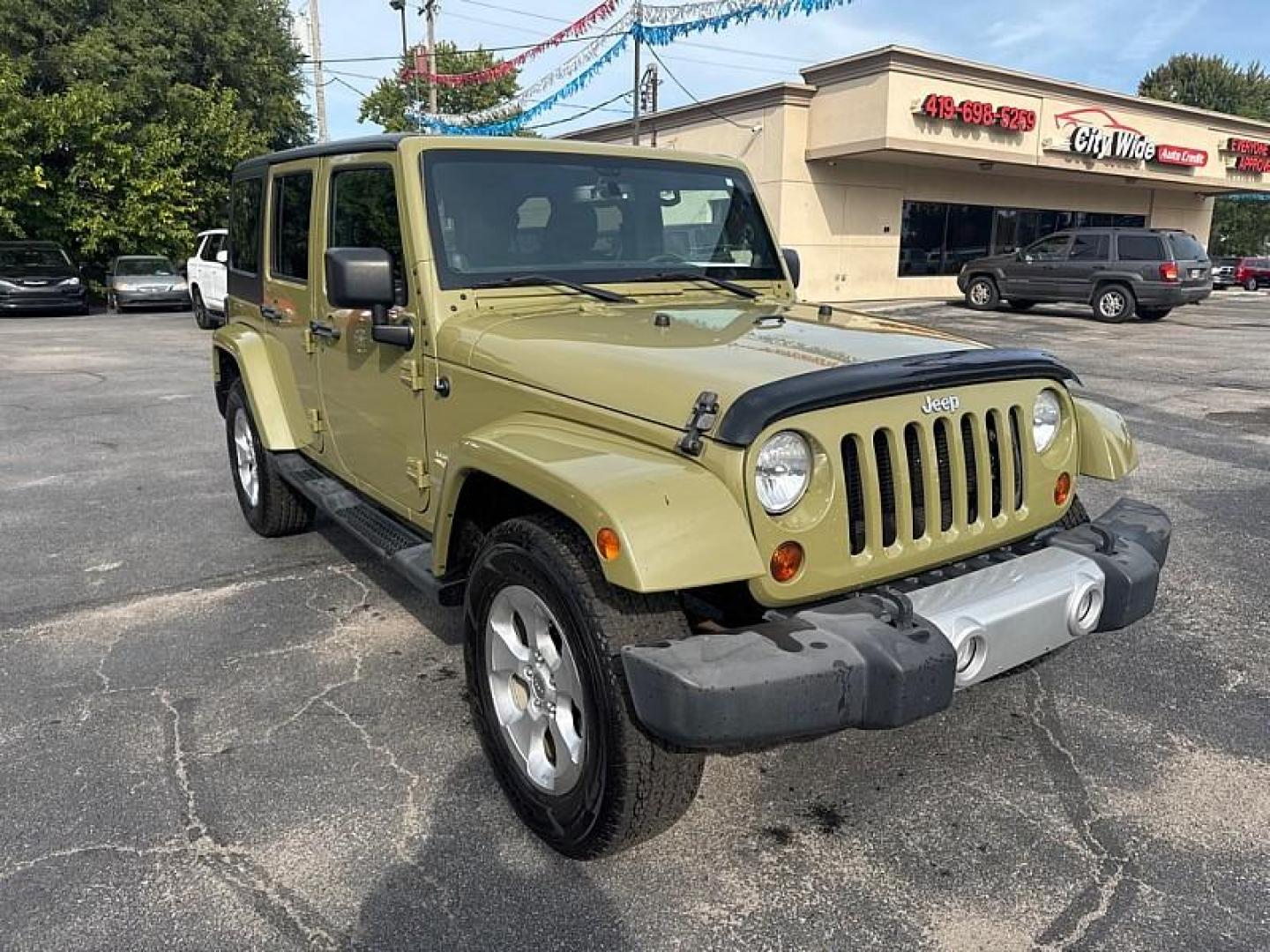 2013 GREEN /BLACK Jeep Wrangler Unlimited Sahara 4WD (1C4BJWEG0DL) with an 3.6L V6 DOHC 24V FFV engine, Automatic 5-Spd transmission, located at 3304 Woodville Road, Northwood, OH, 43619, (419) 210-8019, 41.612694, -83.480743 - Your #1 Destination for Auto Loans and mdash;No Matter Your Credit!At our dealership, we believe everyone deserves the opportunity to drive their dream car and mdash;whether you have good credit, bad credit, or no credit at all. With a wide selection of hundreds of cars, trucks, and SUVs, you'll fin - Photo#6