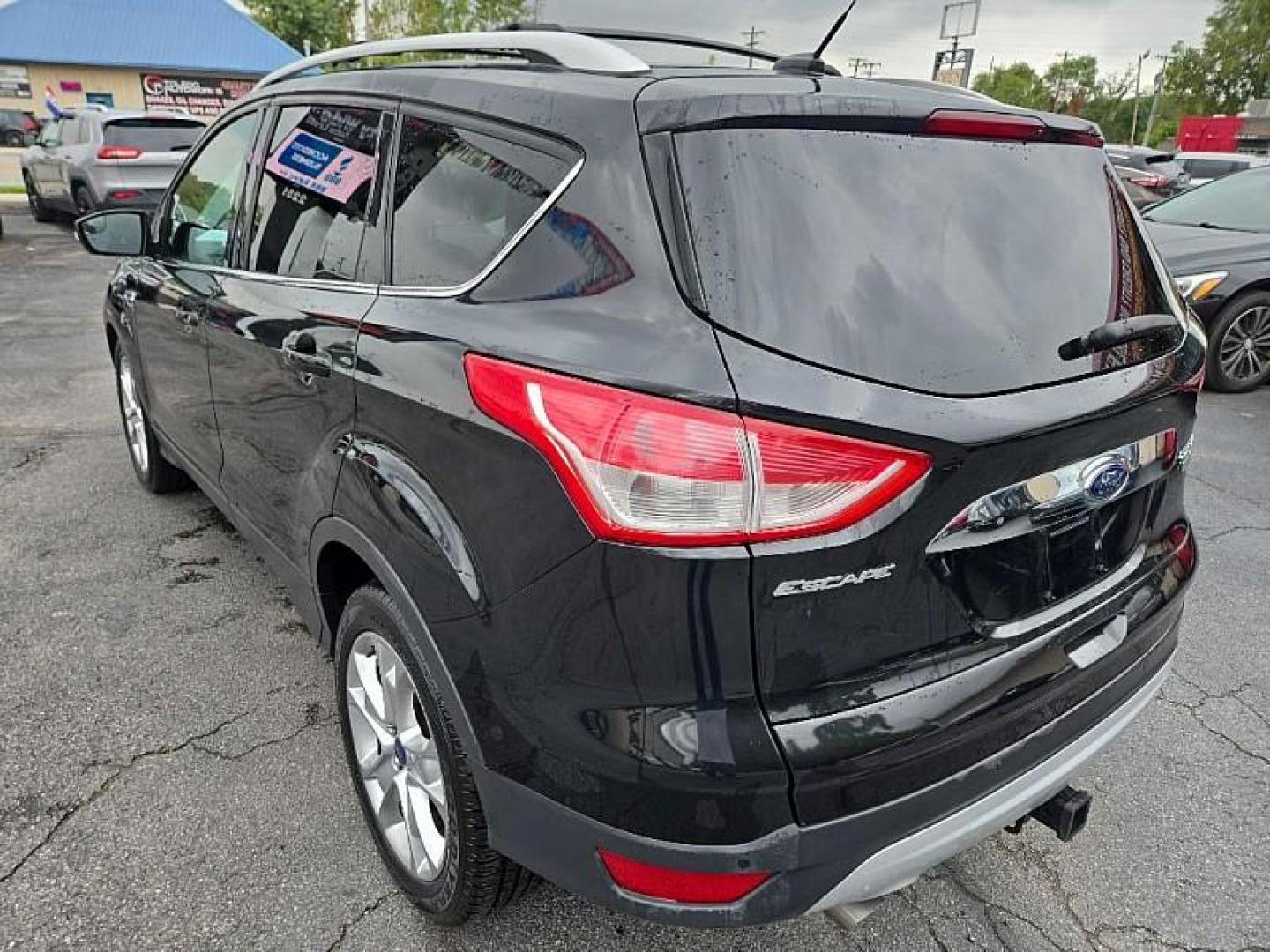 2014 BLACK /BLACK Ford Escape Titanium FWD (1FMCU0J9XEU) with an 2.0L L4 DOHC 16V engine, 6-Speed Automatic transmission, located at 3304 Woodville Road, Northwood, OH, 43619, (419) 210-8019, 41.612694, -83.480743 - Photo#2