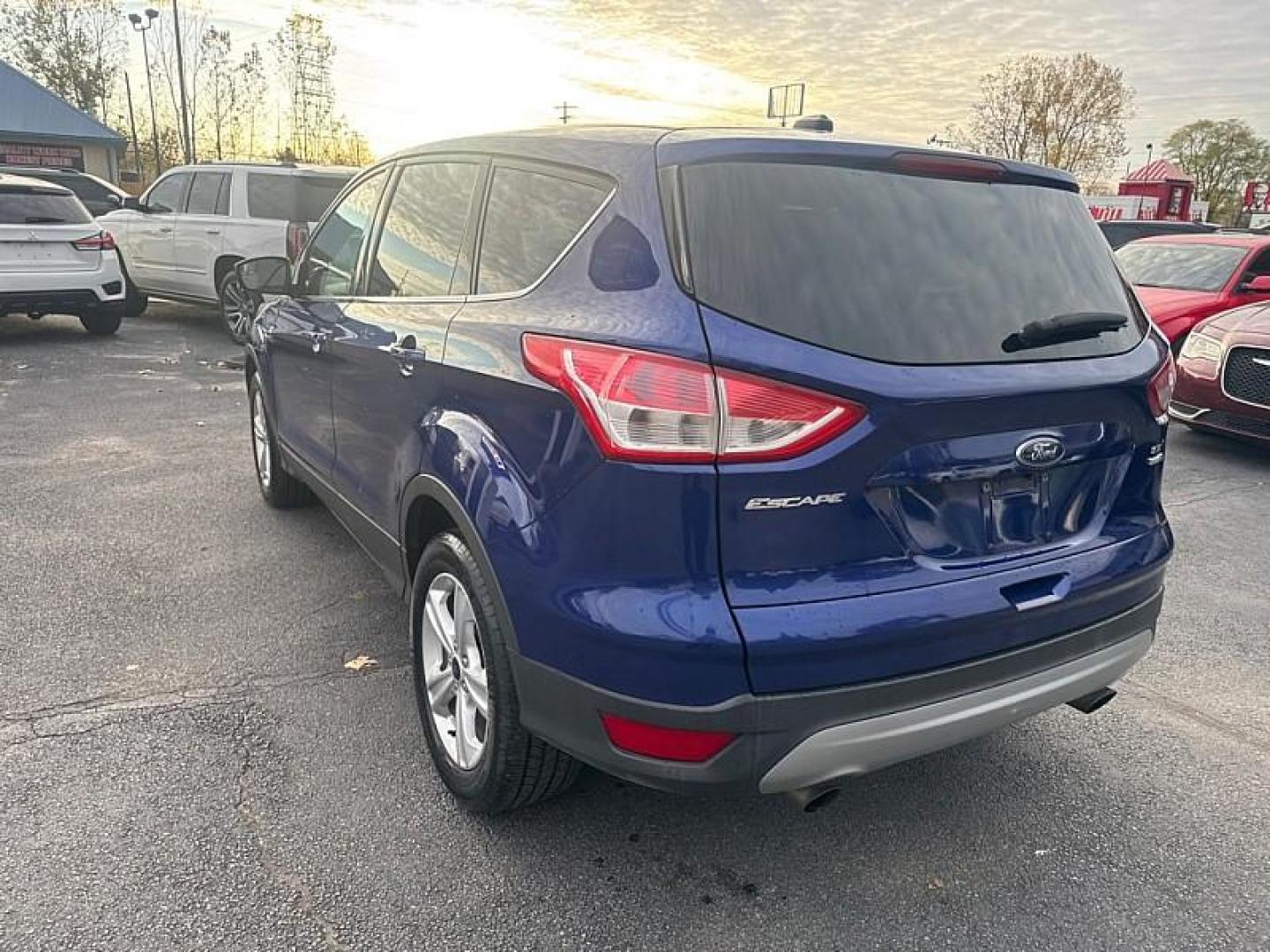 2016 BLUE /GRAY Ford Escape SE 4WD (1FMCU9GX0GU) with an 1.6L L4 DOHC 16V engine, 6-Speed Automatic transmission, located at 3304 Woodville Road, Northwood, OH, 43619, (419) 210-8019, 41.612694, -83.480743 - Your #1 Destination for Auto Loans and mdash;No Matter Your Credit!At our dealership, we believe everyone deserves the opportunity to drive their dream car and mdash;whether you have good credit, bad credit, or no credit at all. With a wide selection of hundreds of cars, trucks, and SUVs, you'll fin - Photo#2