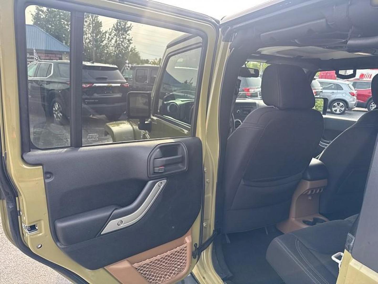 2013 GREEN /BLACK Jeep Wrangler Unlimited Sahara 4WD (1C4BJWEG0DL) with an 3.6L V6 DOHC 24V FFV engine, Automatic 5-Spd transmission, located at 3304 Woodville Road, Northwood, OH, 43619, (419) 210-8019, 41.612694, -83.480743 - Your #1 Destination for Auto Loans and mdash;No Matter Your Credit!At our dealership, we believe everyone deserves the opportunity to drive their dream car and mdash;whether you have good credit, bad credit, or no credit at all. With a wide selection of hundreds of cars, trucks, and SUVs, you'll fin - Photo#10