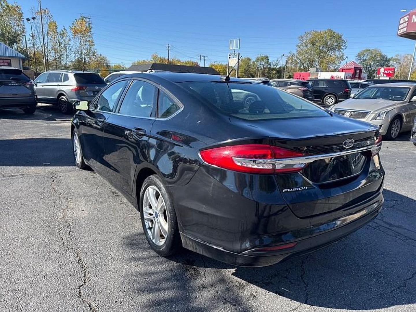 2018 BLACK /BLACK Ford Fusion SE (3FA6P0H75JR) with an 2.5L L4 DOHC 16V engine, 6A transmission, located at 3304 Woodville Road, Northwood, OH, 43619, (419) 210-8019, 41.612694, -83.480743 - Your #1 Destination for Auto Loans and mdash;No Matter Your Credit!At our dealership, we believe everyone deserves the opportunity to drive their dream car and mdash;whether you have good credit, bad credit, or no credit at all. With a wide selection of hundreds of cars, trucks, and SUVs, you'll fin - Photo#2