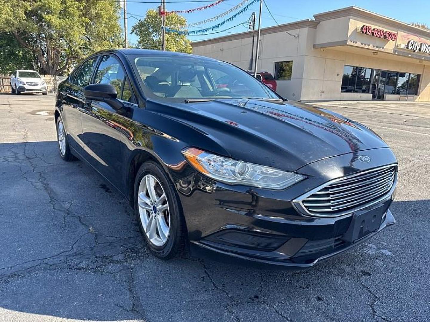 2018 BLACK /BLACK Ford Fusion SE (3FA6P0H75JR) with an 2.5L L4 DOHC 16V engine, 6A transmission, located at 3304 Woodville Road, Northwood, OH, 43619, (419) 210-8019, 41.612694, -83.480743 - Your #1 Destination for Auto Loans and mdash;No Matter Your Credit!At our dealership, we believe everyone deserves the opportunity to drive their dream car and mdash;whether you have good credit, bad credit, or no credit at all. With a wide selection of hundreds of cars, trucks, and SUVs, you'll fin - Photo#6