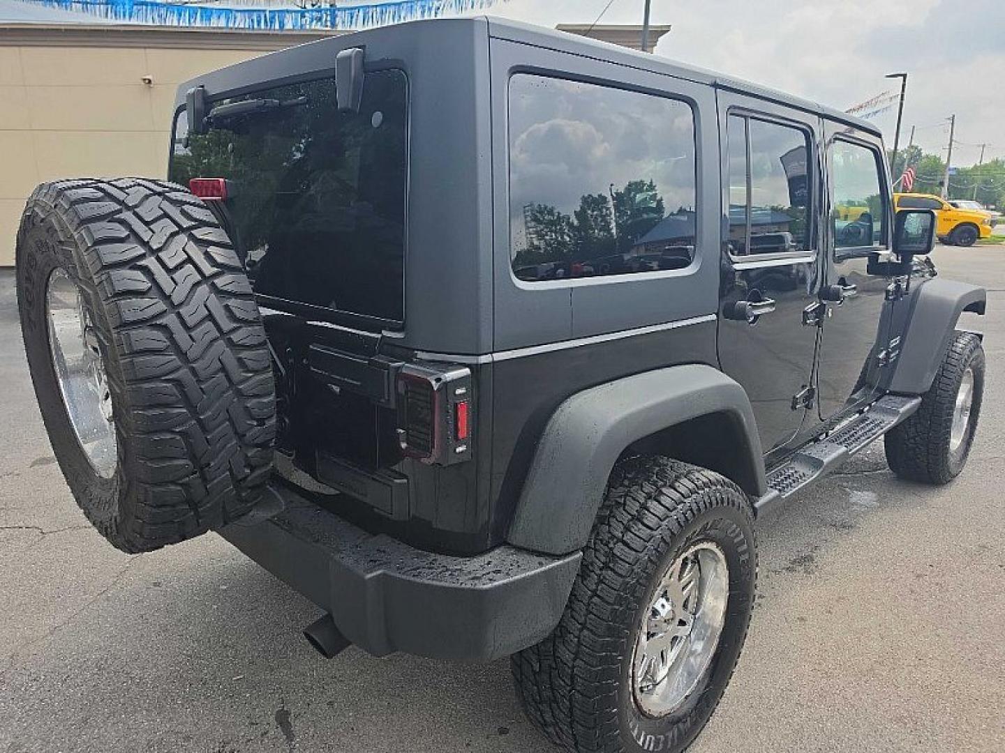 2014 BLACK /BLACK Jeep Wrangler Unlimited Sport 4WD (1C4BJWDG3EL) with an 3.6L V6 DOHC 24V FFV engine, Automatic 5-Spd transmission, located at 3304 Woodville Road, Northwood, OH, 43619, (419) 210-8019, 41.612694, -83.480743 - Your #1 Destination for Auto Loans and mdash;No Matter Your Credit!At our dealership, we believe everyone deserves the opportunity to drive their dream car and mdash;whether you have good credit, bad credit, or no credit at all. With a wide selection of hundreds of cars, trucks, and SUVs, you'll fin- Photo#4