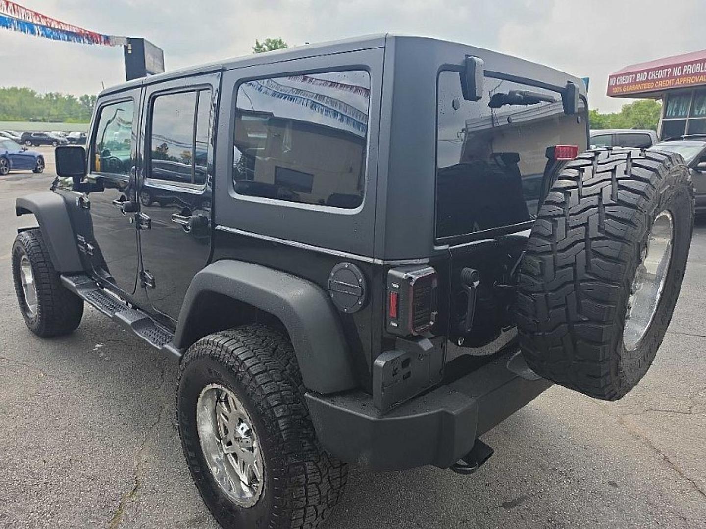 2014 BLACK /BLACK Jeep Wrangler Unlimited Sport 4WD (1C4BJWDG3EL) with an 3.6L V6 DOHC 24V FFV engine, Automatic 5-Spd transmission, located at 3304 Woodville Road, Northwood, OH, 43619, (419) 210-8019, 41.612694, -83.480743 - Your #1 Destination for Auto Loans and mdash;No Matter Your Credit!At our dealership, we believe everyone deserves the opportunity to drive their dream car and mdash;whether you have good credit, bad credit, or no credit at all. With a wide selection of hundreds of cars, trucks, and SUVs, you'll fin- Photo#2