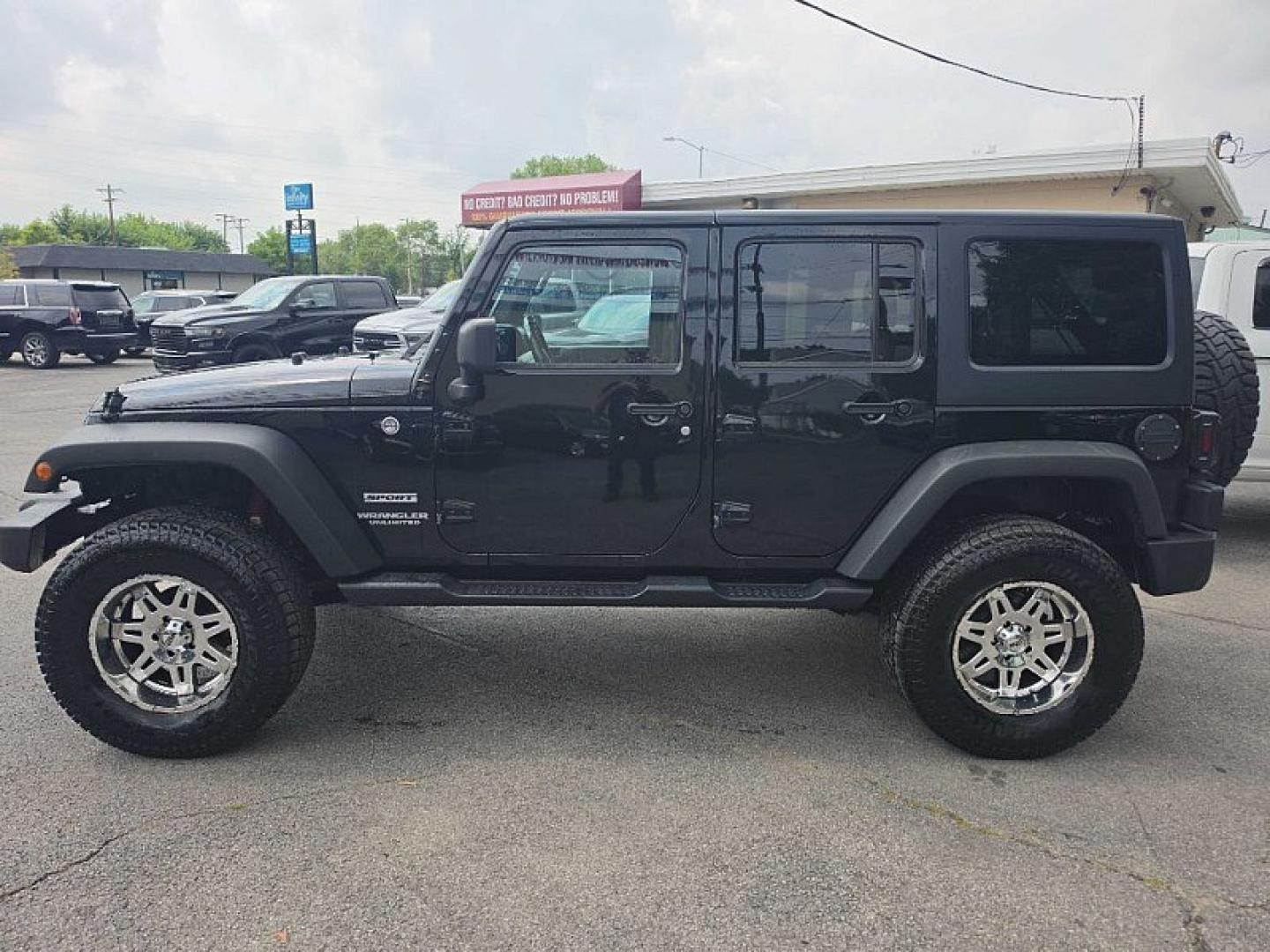 2014 BLACK /BLACK Jeep Wrangler Unlimited Sport 4WD (1C4BJWDG3EL) with an 3.6L V6 DOHC 24V FFV engine, Automatic 5-Spd transmission, located at 3304 Woodville Road, Northwood, OH, 43619, (419) 210-8019, 41.612694, -83.480743 - Your #1 Destination for Auto Loans and mdash;No Matter Your Credit!At our dealership, we believe everyone deserves the opportunity to drive their dream car and mdash;whether you have good credit, bad credit, or no credit at all. With a wide selection of hundreds of cars, trucks, and SUVs, you'll fin- Photo#1