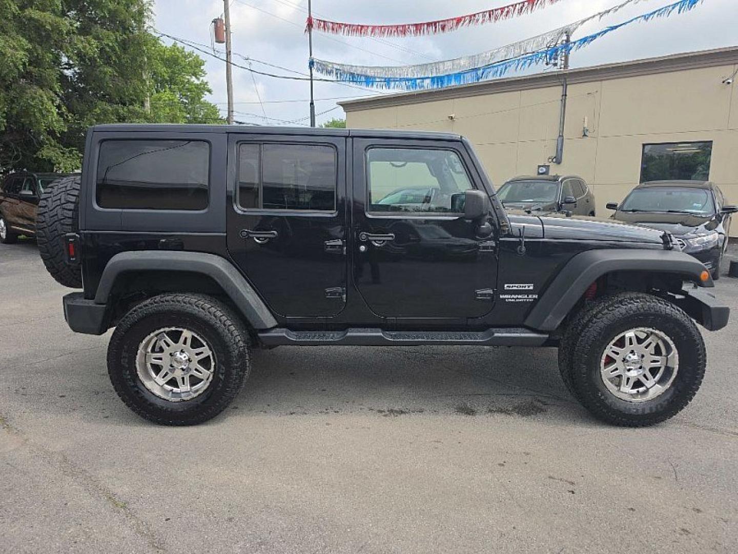 2014 BLACK /BLACK Jeep Wrangler Unlimited Sport 4WD (1C4BJWDG3EL) with an 3.6L V6 DOHC 24V FFV engine, Automatic 5-Spd transmission, located at 3304 Woodville Road, Northwood, OH, 43619, (419) 210-8019, 41.612694, -83.480743 - Your #1 Destination for Auto Loans and mdash;No Matter Your Credit!At our dealership, we believe everyone deserves the opportunity to drive their dream car and mdash;whether you have good credit, bad credit, or no credit at all. With a wide selection of hundreds of cars, trucks, and SUVs, you'll fin- Photo#5
