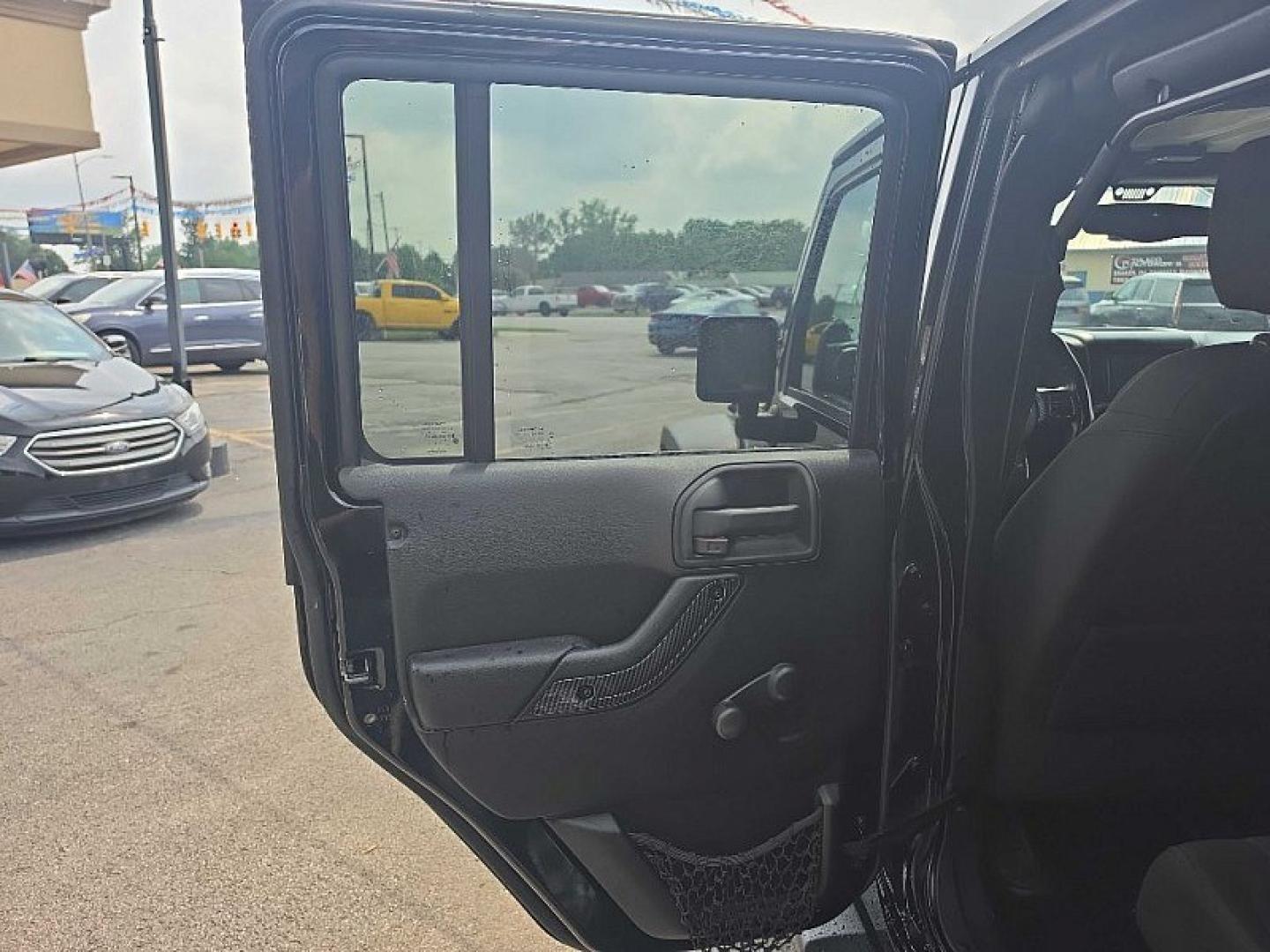 2014 BLACK /BLACK Jeep Wrangler Unlimited Sport 4WD (1C4BJWDG3EL) with an 3.6L V6 DOHC 24V FFV engine, Automatic 5-Spd transmission, located at 3304 Woodville Road, Northwood, OH, 43619, (419) 210-8019, 41.612694, -83.480743 - Your #1 Destination for Auto Loans and mdash;No Matter Your Credit!At our dealership, we believe everyone deserves the opportunity to drive their dream car and mdash;whether you have good credit, bad credit, or no credit at all. With a wide selection of hundreds of cars, trucks, and SUVs, you'll fin- Photo#10