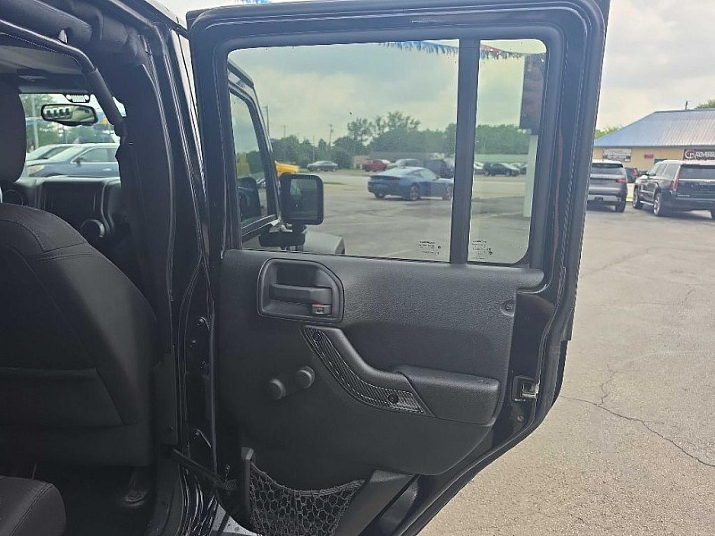 2014 BLACK /BLACK Jeep Wrangler Unlimited Sport 4WD (1C4BJWDG3EL) with an 3.6L V6 DOHC 24V FFV engine, Automatic 5-Spd transmission, located at 3304 Woodville Road, Northwood, OH, 43619, (419) 210-8019, 41.612694, -83.480743 - Your #1 Destination for Auto Loans and mdash;No Matter Your Credit!At our dealership, we believe everyone deserves the opportunity to drive their dream car and mdash;whether you have good credit, bad credit, or no credit at all. With a wide selection of hundreds of cars, trucks, and SUVs, you'll fin- Photo#14
