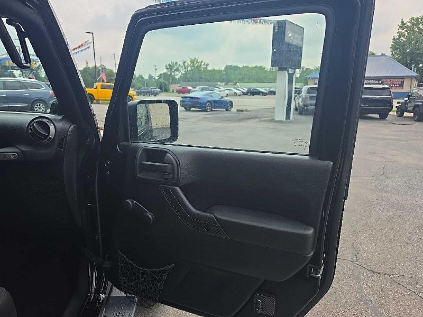 2014 BLACK /BLACK Jeep Wrangler Unlimited Sport 4WD (1C4BJWDG3EL) with an 3.6L V6 DOHC 24V FFV engine, Automatic 5-Spd transmission, located at 3304 Woodville Road, Northwood, OH, 43619, (419) 210-8019, 41.612694, -83.480743 - Your #1 Destination for Auto Loans and mdash;No Matter Your Credit!At our dealership, we believe everyone deserves the opportunity to drive their dream car and mdash;whether you have good credit, bad credit, or no credit at all. With a wide selection of hundreds of cars, trucks, and SUVs, you'll fin- Photo#16