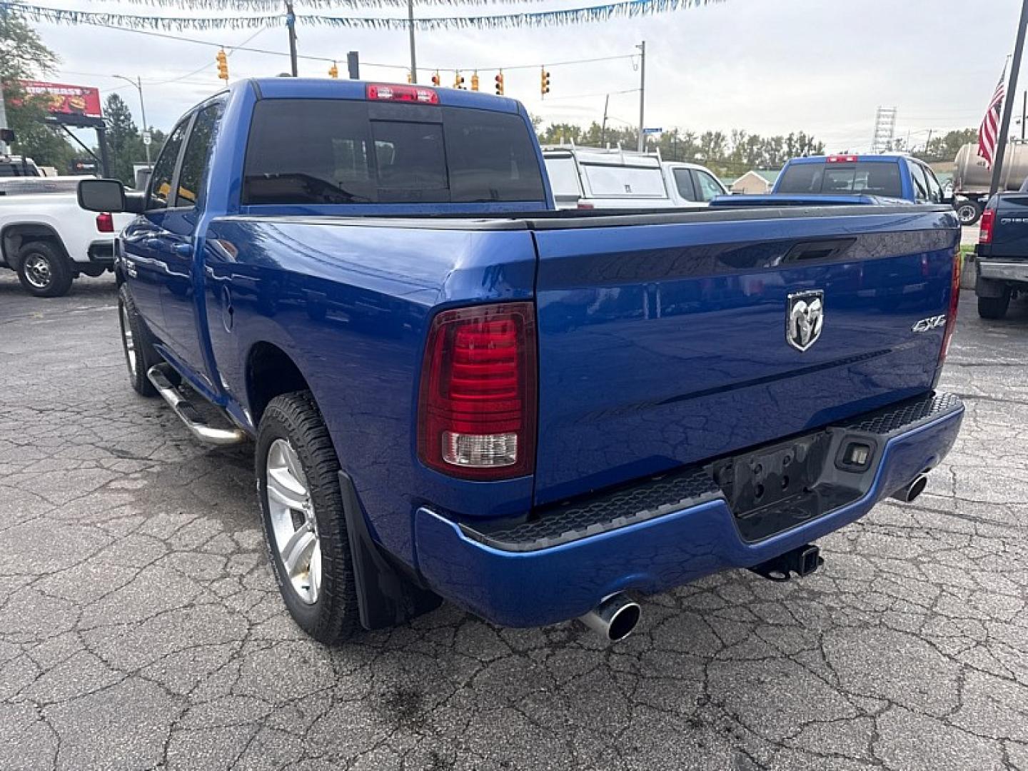 2015 BLUE /BLACK Ram 1500 Sport Quad Cab 4WD (1C6RR7HT4FS) with an 5.7L V8 OHV 16V engine, 6A transmission, located at 3304 Woodville Road, Northwood, OH, 43619, (419) 210-8019, 41.612694, -83.480743 - Your #1 Destination for Auto Loans and mdash;No Matter Your Credit!At our dealership, we believe everyone deserves the opportunity to drive their dream car and mdash;whether you have good credit, bad credit, or no credit at all. With a wide selection of hundreds of cars, trucks, and SUVs, you'll fin- Photo#2